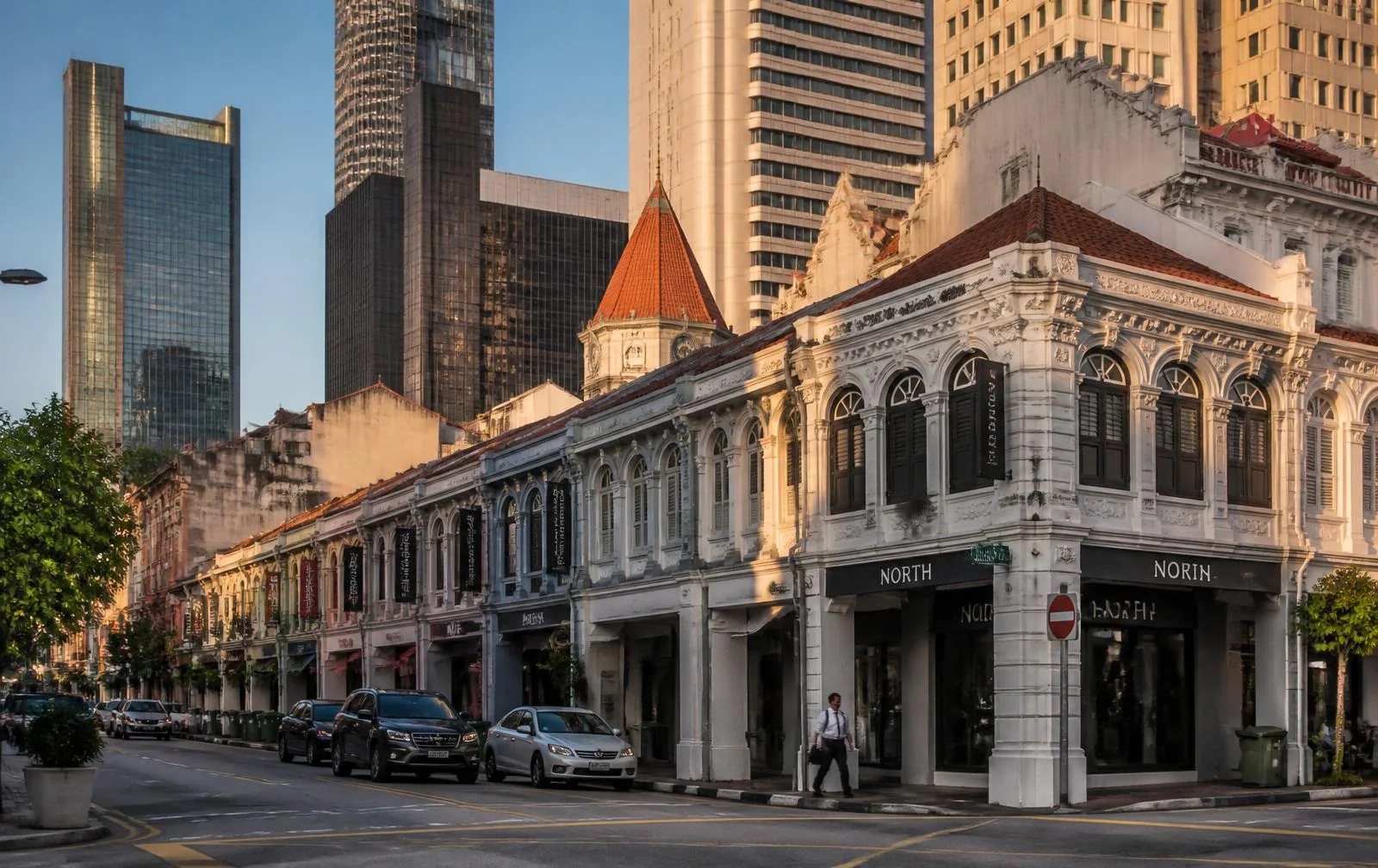 Heritage shophouses in Singapore's business district beside modern towers
